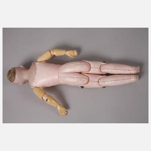 Drei kleine Porzellankopfpuppen mit Kindergesicht