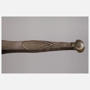 Zwei Zuckerzangen und ein Nadelbehälter