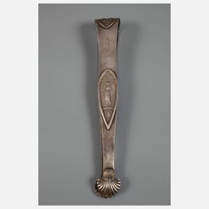 Zwei Zuckerzangen und ein Nadelbehälter