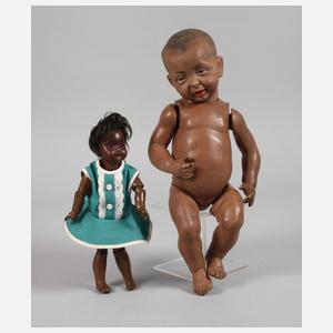 Zwei Porzellankopfpuppen als Afrikaner