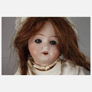 Zwei kleine Porzellankopfpuppen