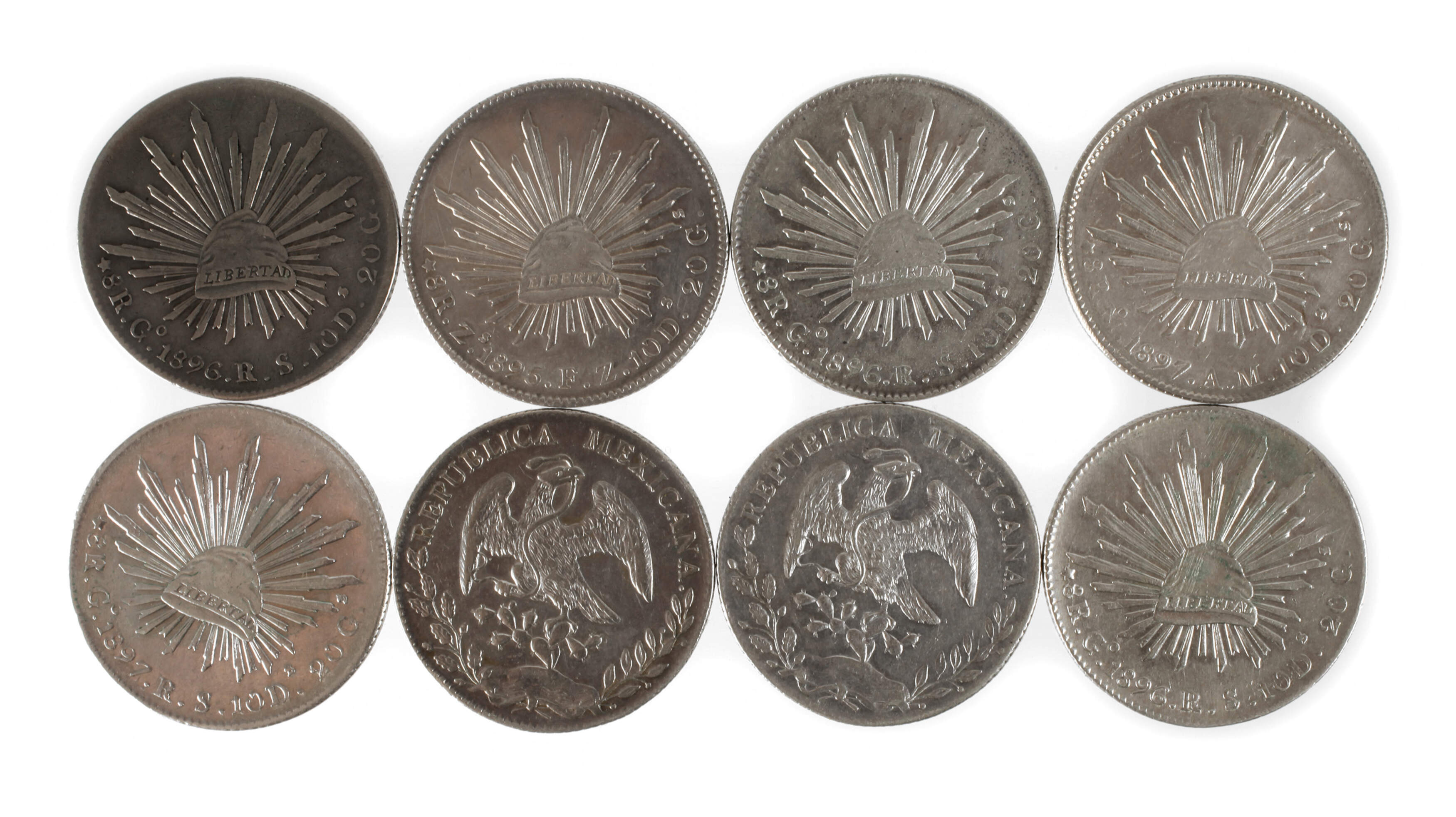 Acht Silbermünzen Mexiko