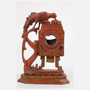 Drei geschnitzte Uhrenständer