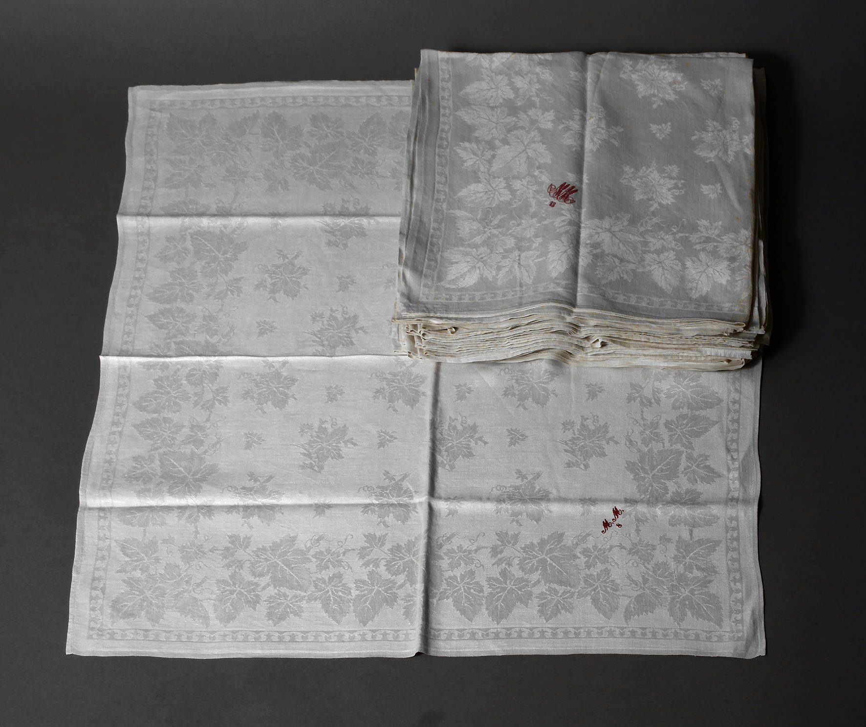 Sechzehn Servietten mit Weinlaubdekor