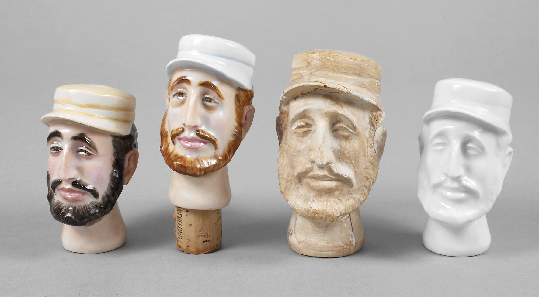 Vier figürliche Flaschenstopfen