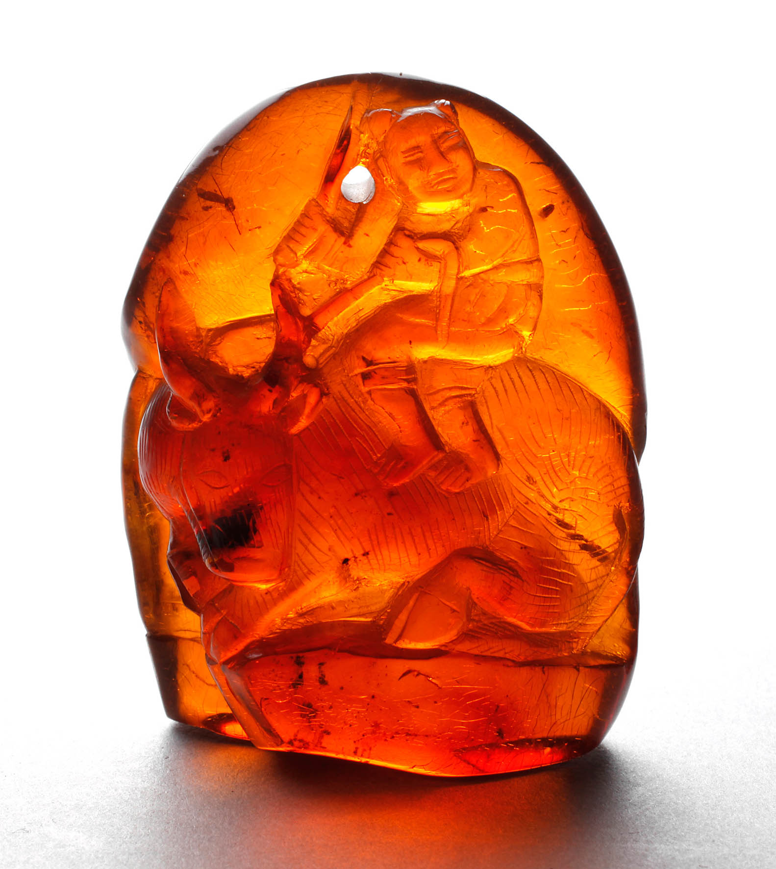 Bernsteinschnitzerei Bauer auf Büffel