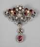 Filigrane Brosche mit Rubin, Granat und Diamanten