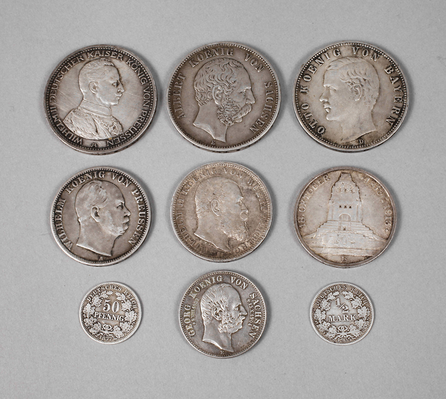 Neun Reichsmünzen