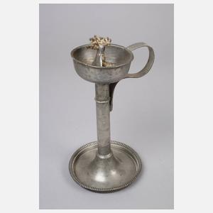 Vier Kerzenleuchter und eine Öllampe